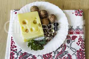 Cheese and walnuts on a plate.
