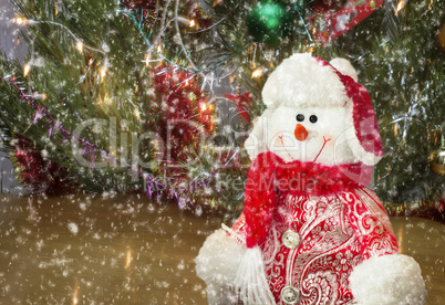 Christmas greetings, snowman with a Christmas tree.