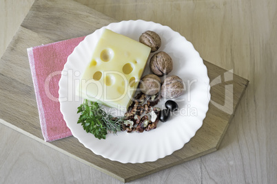 Cheese and walnuts on a plate.