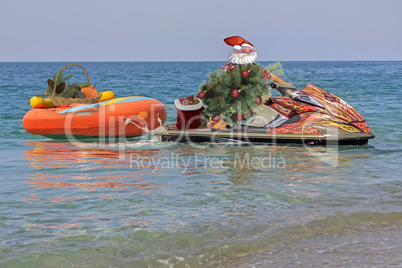 Christmas beach Santa Claus on a water scooter.