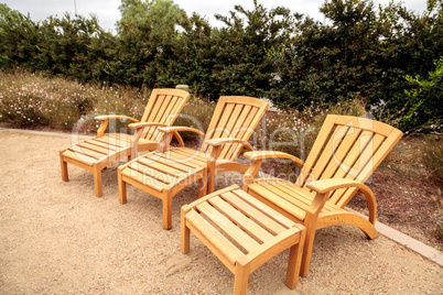 Wood patio lounge chairs in the backyard