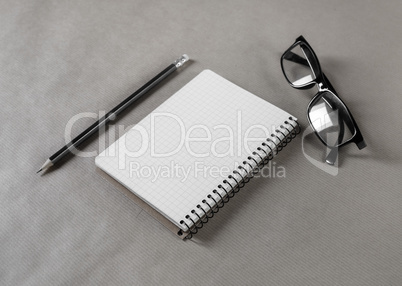 Notepad, glasses and pencil