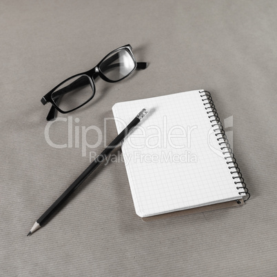 Notebook, glasses, pencil