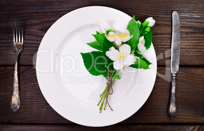 empty white round plate with iron vintage cutlery