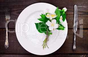 empty white round plate with iron vintage cutlery