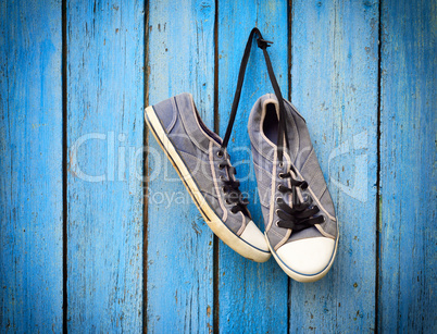 old men's shabby textile sneakers hang