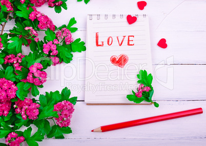 paper notebook with love letter and red heart