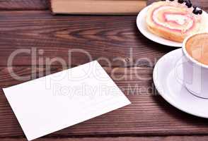 empty white paper card on the table, side espresso cup