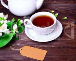 black tea in a white cup with a saucer