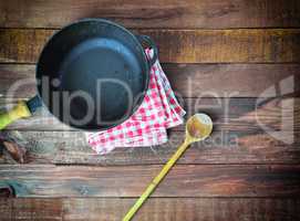 deep cast-iron frying pan with a wooden spoon, top view