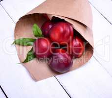 ripe red peaches in a paper bag