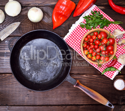 empty black cast-iron frying pan with a wooden handle