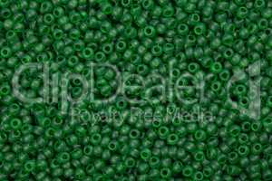 Background of shiny green glass beads.
