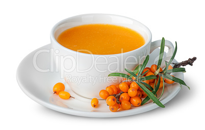 Juice from sea-buckthorn in a cup with berries