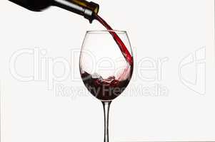 Pouring wine. Isolated on white background.