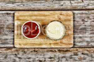 Ketchup and mayonnaise in serving dishes, restaurant, cafe, fast food