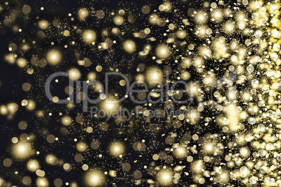 Golden snowflakes swirling on a black background.