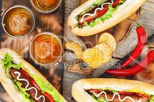 Hotdogs, chips and kraft beer, top view.