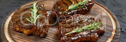 Grilled T-bone Steaks on stone table. Top view with copy space