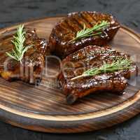 Grilled T-bone Steaks on stone table. Top view with copy space