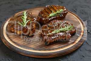 Grilled T-bone Steaks on stone table. Top view with copy space
