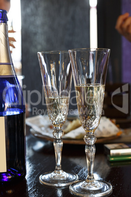 Champagne in glasses and in a bottle on the table in a restaurant