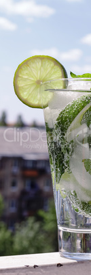 Mojito in a glass on a background of a modern cit