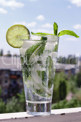 Mojito in a glass on a background of a modern cit