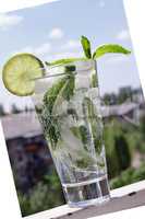 Mojito in a glass on a background of a modern cit