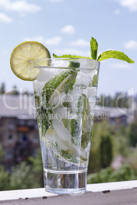 Mojito in a glass on a background of a modern cit