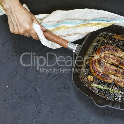 Homemade grilled sausage served by woman in hands