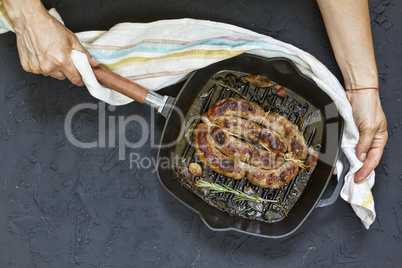 Homemade grilled sausage served by woman in hands