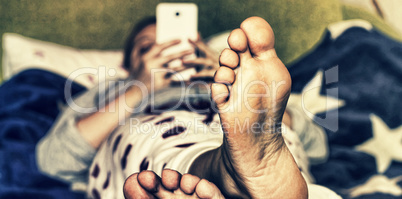 young woman or girl resting on  the couch on a blanket with American flag