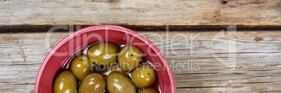 Delicious Olives on a wooden background. View from above