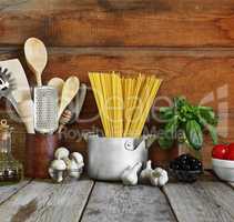 Set of raw ingredients for Italian pasta on a wooden background