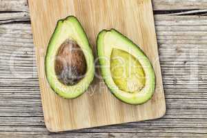 Cut avocado on a wooden board