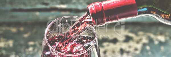Pouring wine Red wine in a glass.