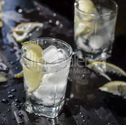 Closeup vodka in a glass with ice, lime vodka, Gin, tonic, tequila