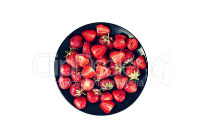 Ripe strawberries in a black plate isolated on white background. Healthy dessert.