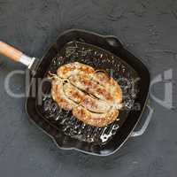 Homemade sausage grilled in a frying pan