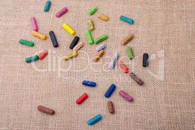 Crayons of various color on a canvas