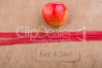 Back to school lettering with apple and a ribbon