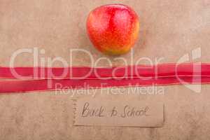 Back to school lettering with apple and a ribbon