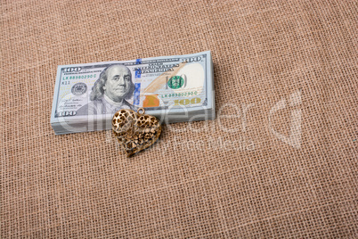 Bundle of US dollar and a heart shape