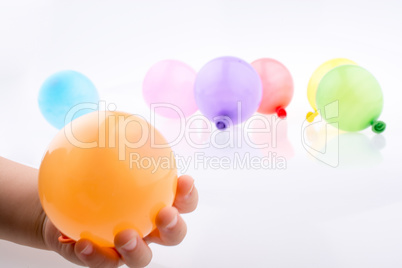 Hand holding a Colorful small balloon in hand