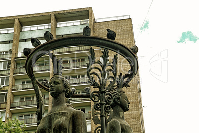 pigeons sitting on the heads of the statues