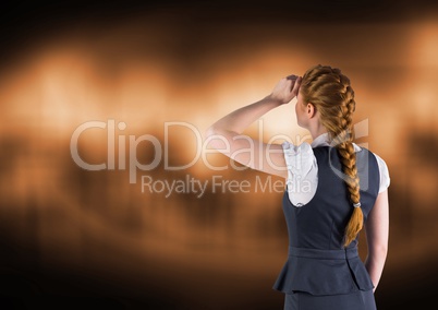 Businesswoman looking at brown background