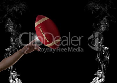 finger touching american football  in smoke