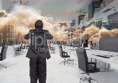 businessman standing in inverted office in the clouds