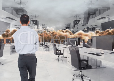 businessman standing in inverted office in clouds